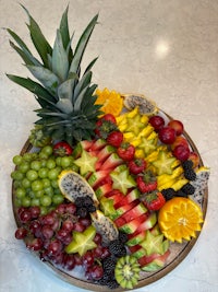 a platter of fruit with a pineapple on it