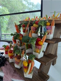a wooden stand with a variety of fruits and vegetables on it