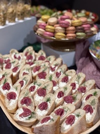 a tray of appetizers and macarons on a table