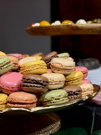 a tray of colorful macarons on a table