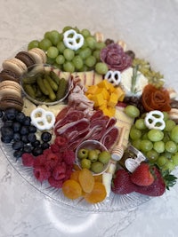 a platter with a variety of fruits and cheeses